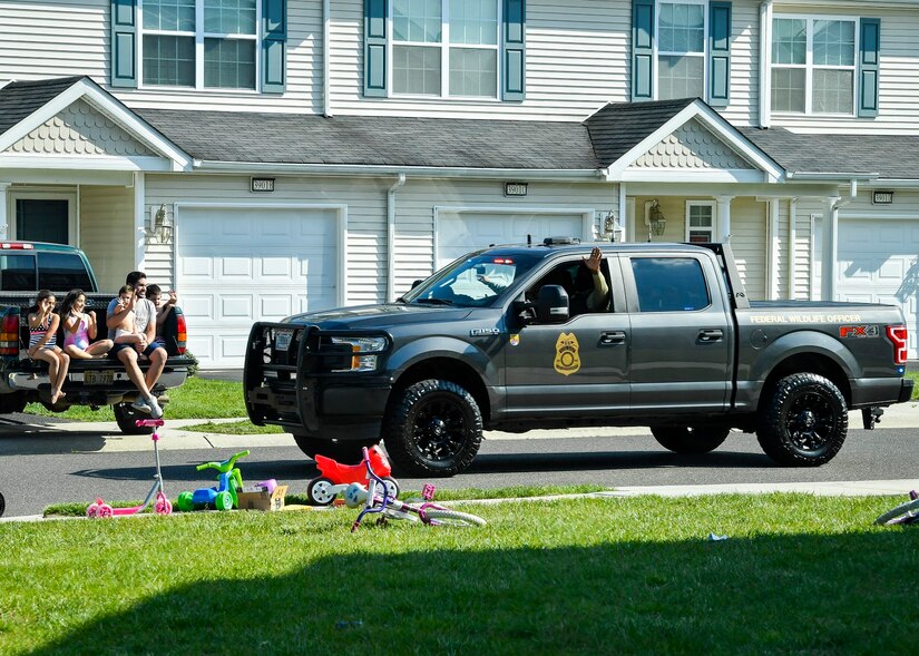 Photo of a police truck driving through a housing development.
