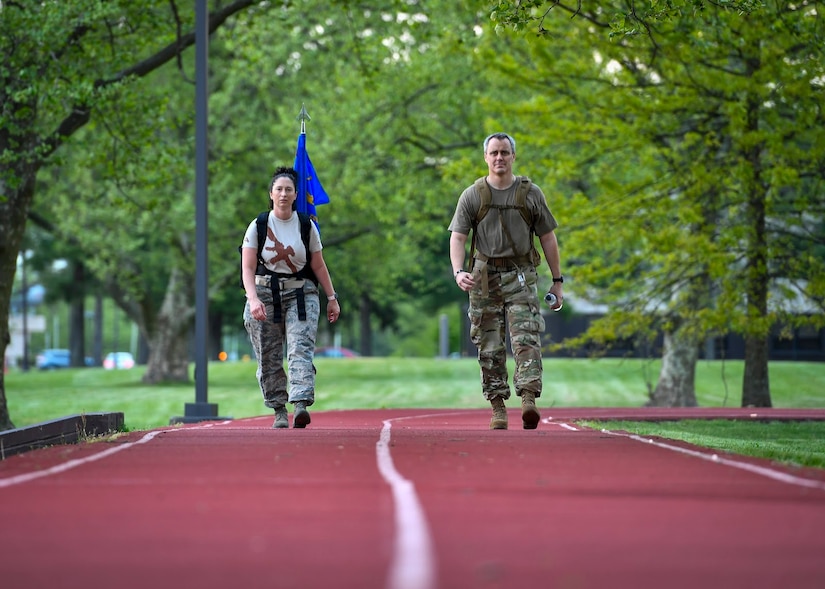A photo of Airmen walking on a track.