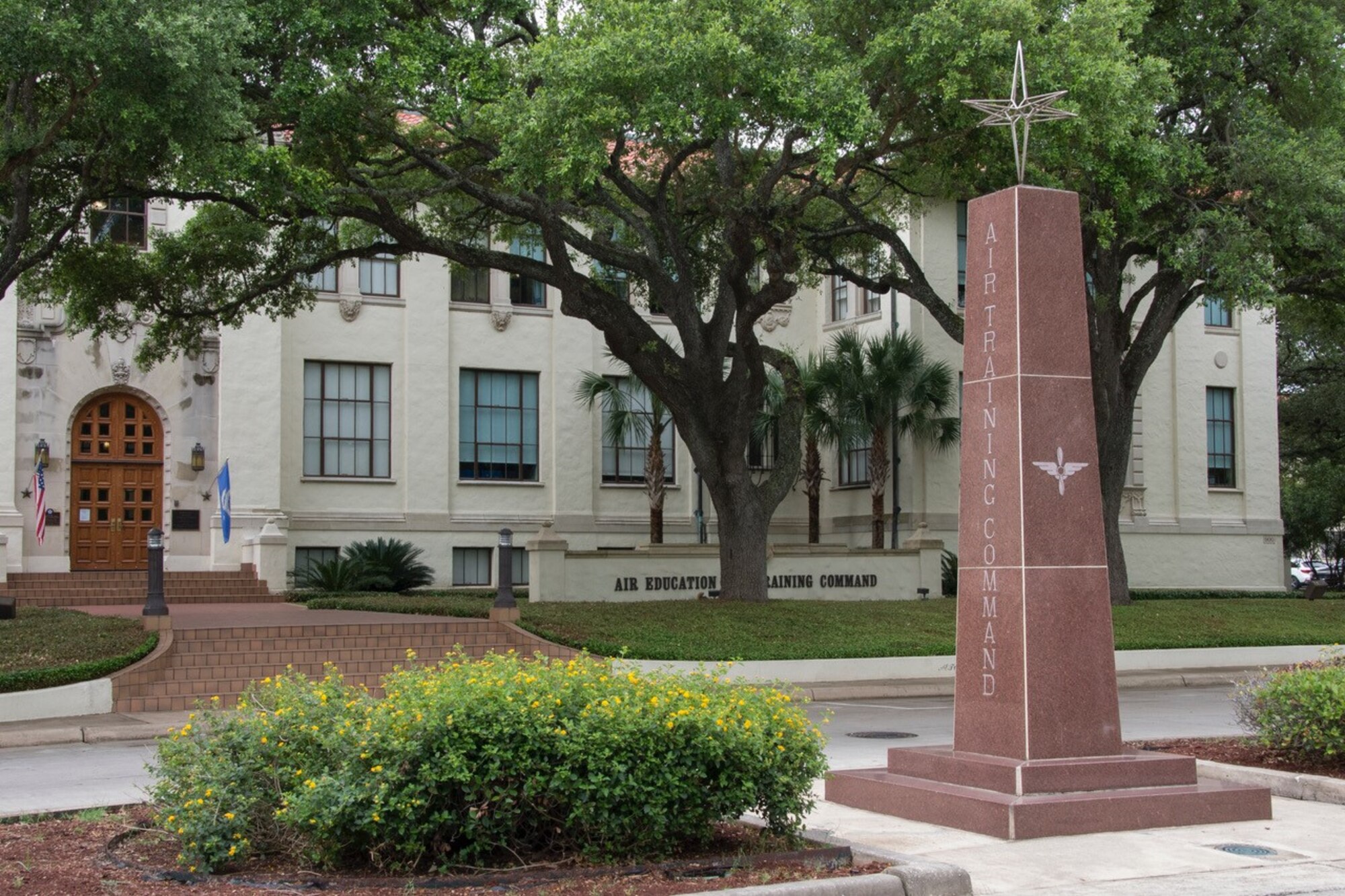 A picture of the Instructor Monument wit the AETC headquarters building in the background.