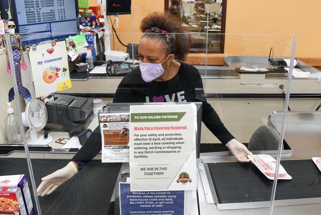 Store teller Wynetta Johnson scans a customer's purchases May 5, 2020, at the Arnold Air Force Base Commissary, while taking measures to reduce the risk of coronavirus transmission. The Arnold Air Force Base Commissary and Base Exchange have remained open to serve their customers throughout the coronavirus crisis. (U.S. Air Force photo by Jill Pickett)