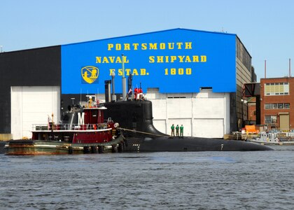 The Virginia-class attack submarine USS New Hampshire (SSN 778) is turned by tug boats before mooring pierside at Portsmouth Naval Shipyard (PNS).