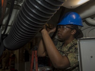 Aviation Electronics Technician 3rd Class Brittany Collins, from Chicago, cleans a ventilation system aboard the aircraft carrier USS George H.W. Bush (CVN 77). GHWB is currently in Norfolk Naval Shipyard for its Docking Planned Incremental Availability (DPIA).