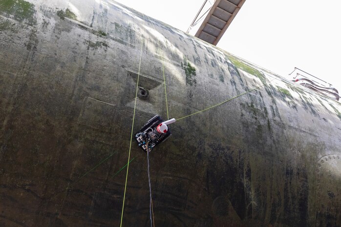 prototype hull-climbing robot conducts its first test on an actual vessel, the Seawolf-class attack submarine USS Connecticut (SSN 22), in dry dock at Puget Sound Naval Shipyard and Intermediate Maintenance Facility (PSNS & IMF).