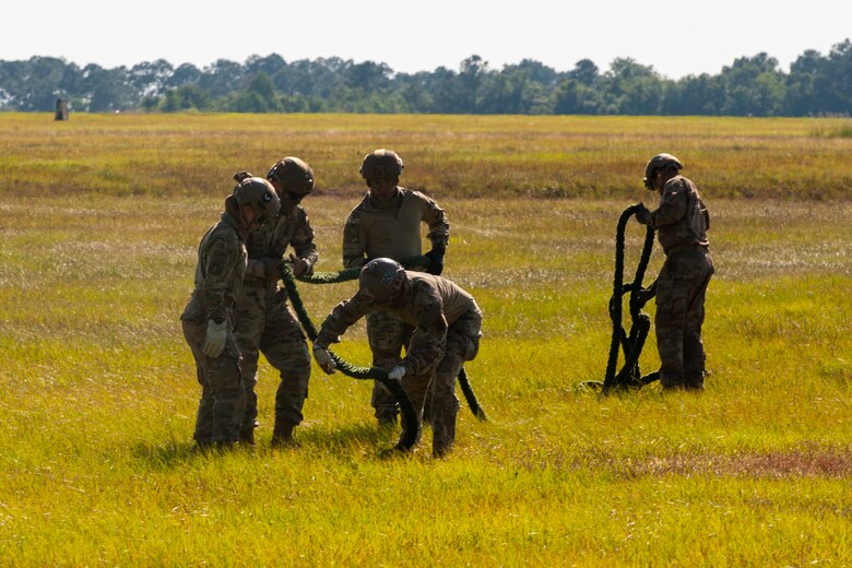 A photo of Airmen collecting a fast rope