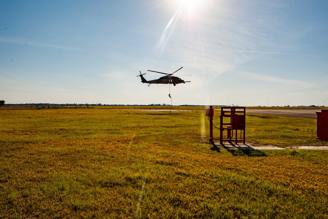 a photo of an Airman exiting a helicopter.