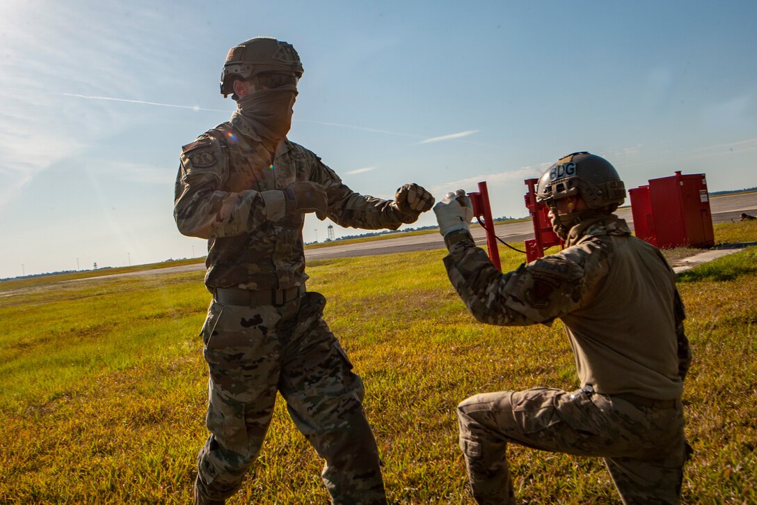 A photo of two Airmen fist bumping.