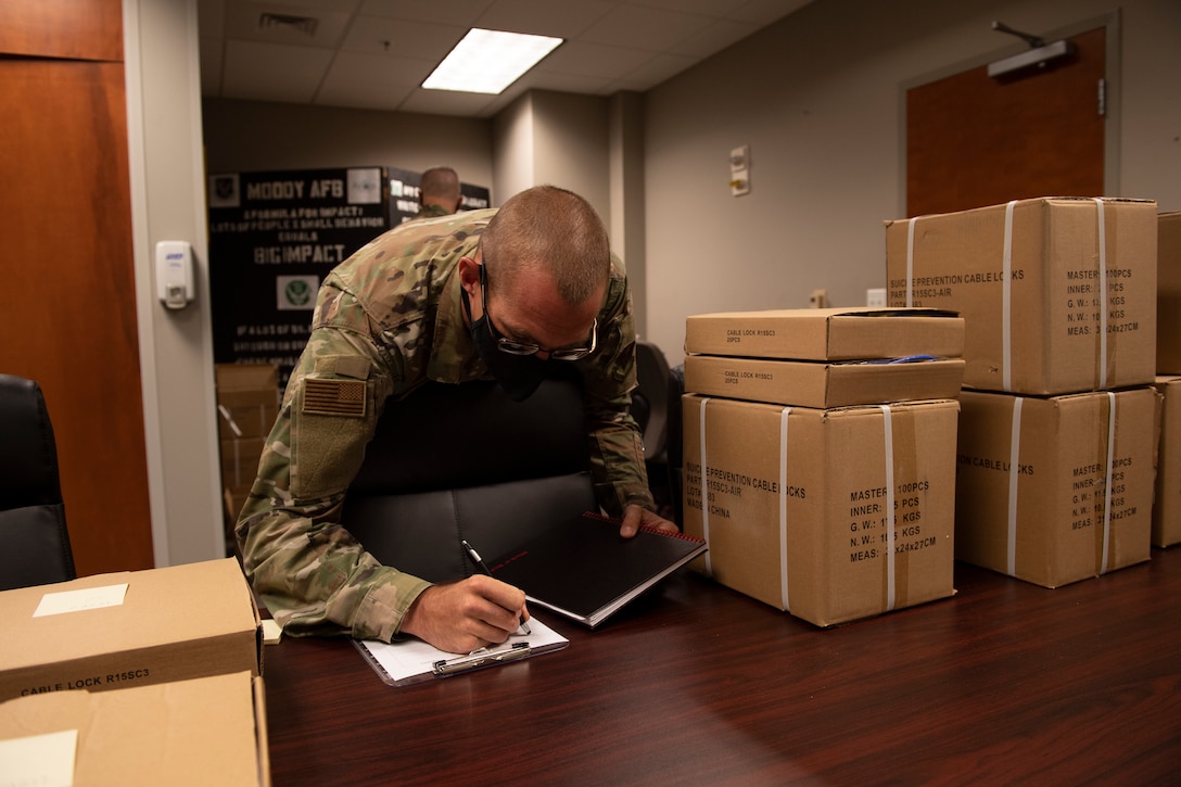 An Airman signs for gun locks