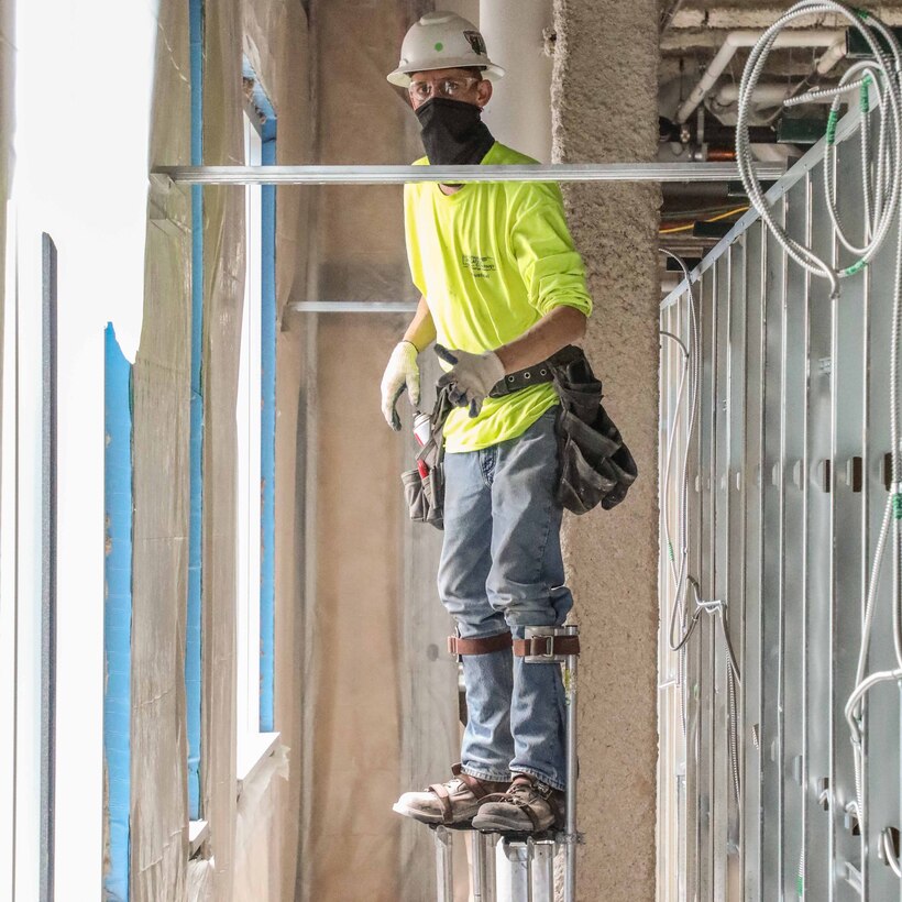 Construction workers building an alternate care facility.