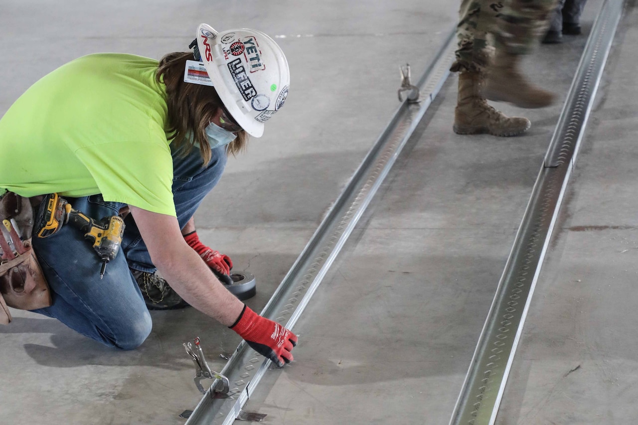 Construction workers building an alternate care facility.