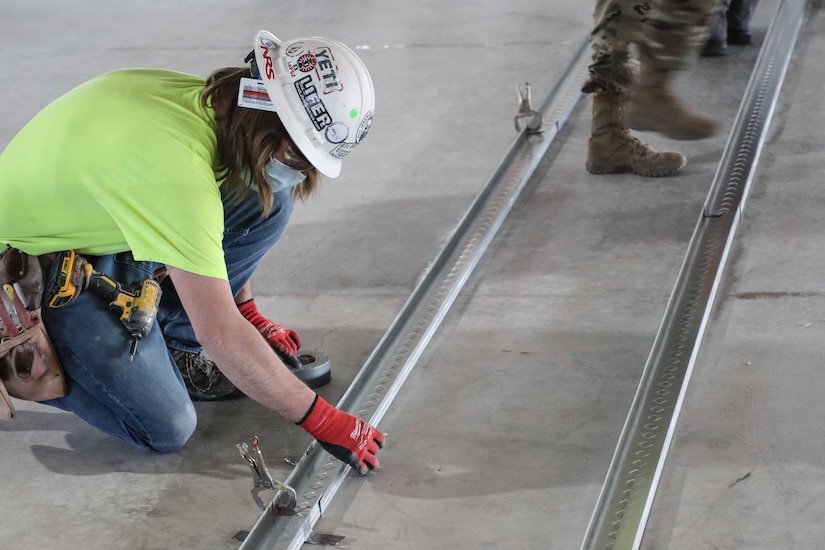 Construction workers building an alternate care facility.