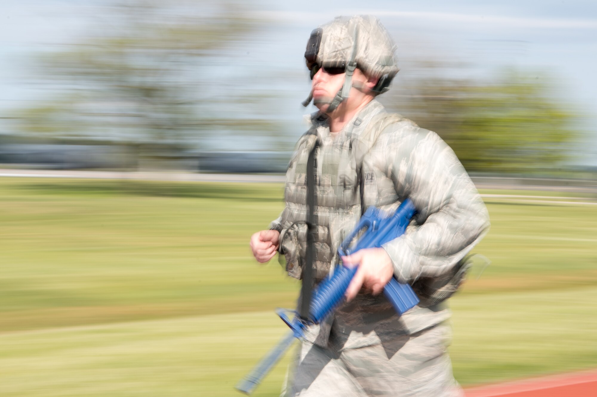 Capt. James Scott, 436th Security Forces Squadron operations officer, runs in full body armor with a training rifle during the 2020 Police Week Ruck March May 14, 2020, at Dover Air Force Base, Delaware. Participants signed up to walk or run for a 30-minute time slot, but some participants went far beyond that, traveling distances of up to 20 miles. (U.S. Air Force photo by Mauricio Campino)