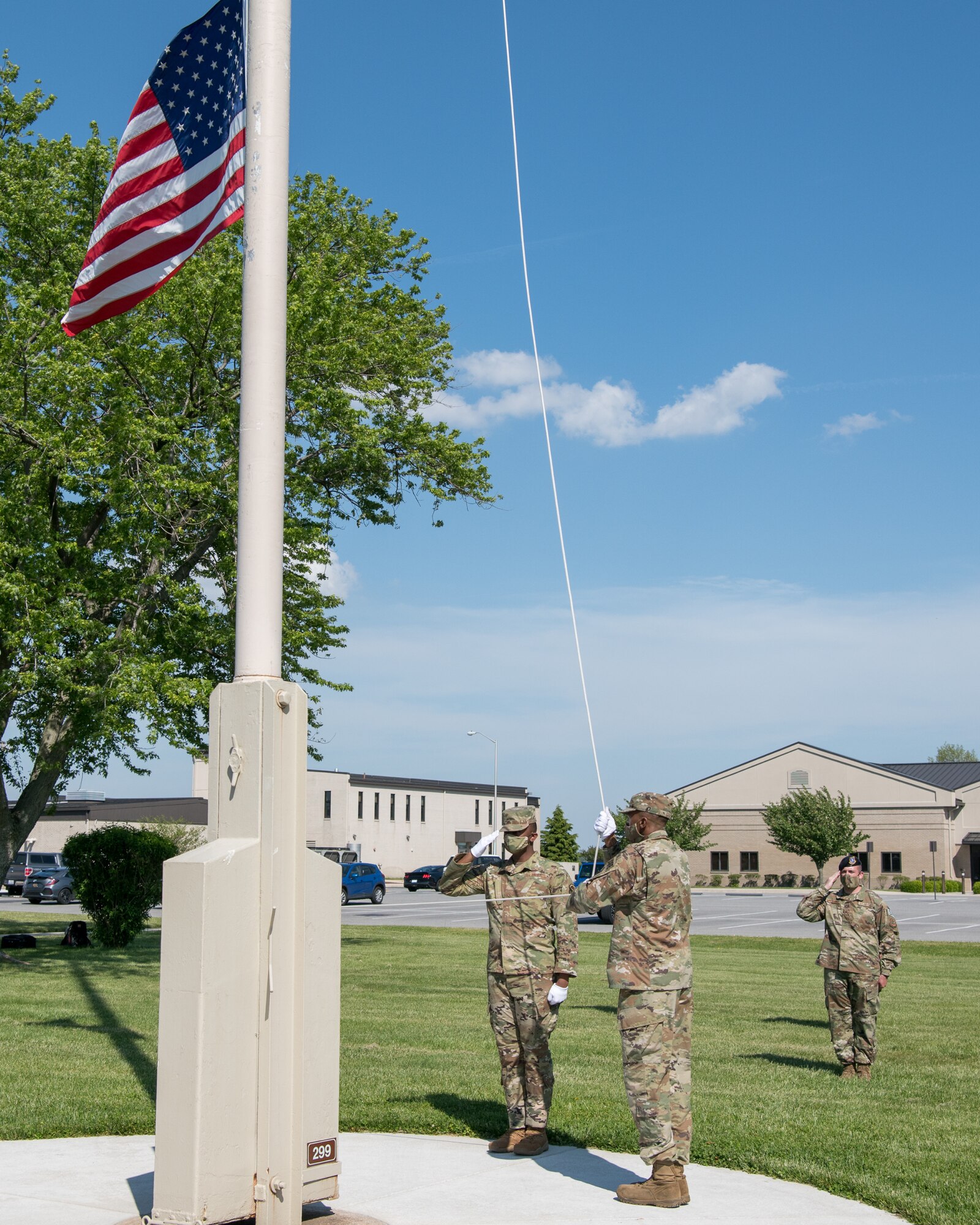 Members of the Dover Air Force Base Honor Guard lower the American flag during a retreat ceremony on Peace Officers Memorial Day May 15, 2020, at Dover Air Force Base, Delaware. The ceremony commemorating fallen military and civilian law enforcement officers marked the end of National Police Week 2020. (U.S. Air Force photo by Mauricio Campino)
