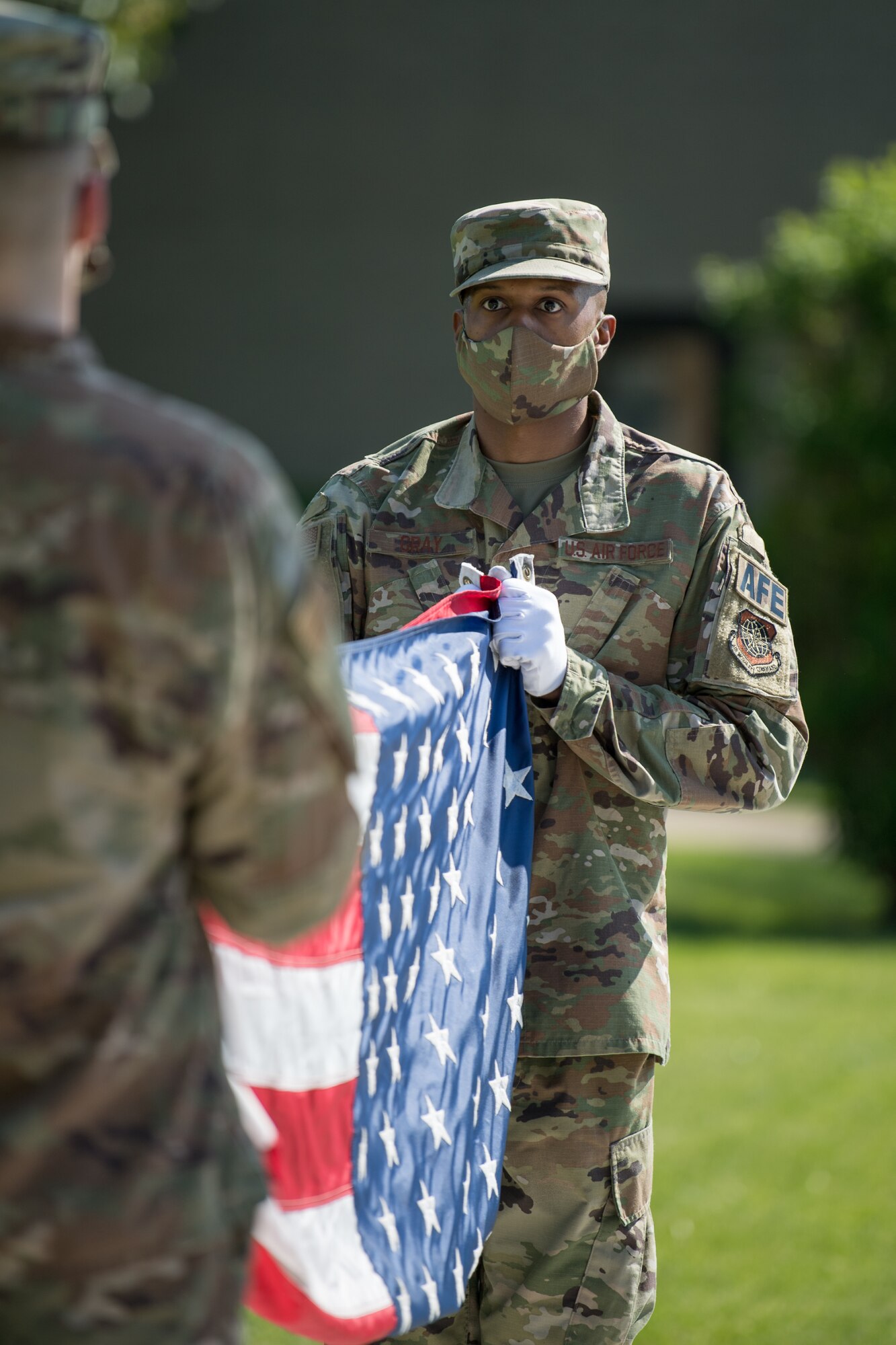 Members of the Dover Air Force Base Honor Guard prepare to fold the American flag during a retreat ceremony on Peace Officers Memorial Day May 15, 2020, at Dover Air Force Base, Delaware. The 436th Security Forces Squadron hosted the ceremony as part of National Police Week, which honors those in the law enforcement profession who have made the ultimate sacrifice. (U.S. Air Force photo by Mauricio Campino)