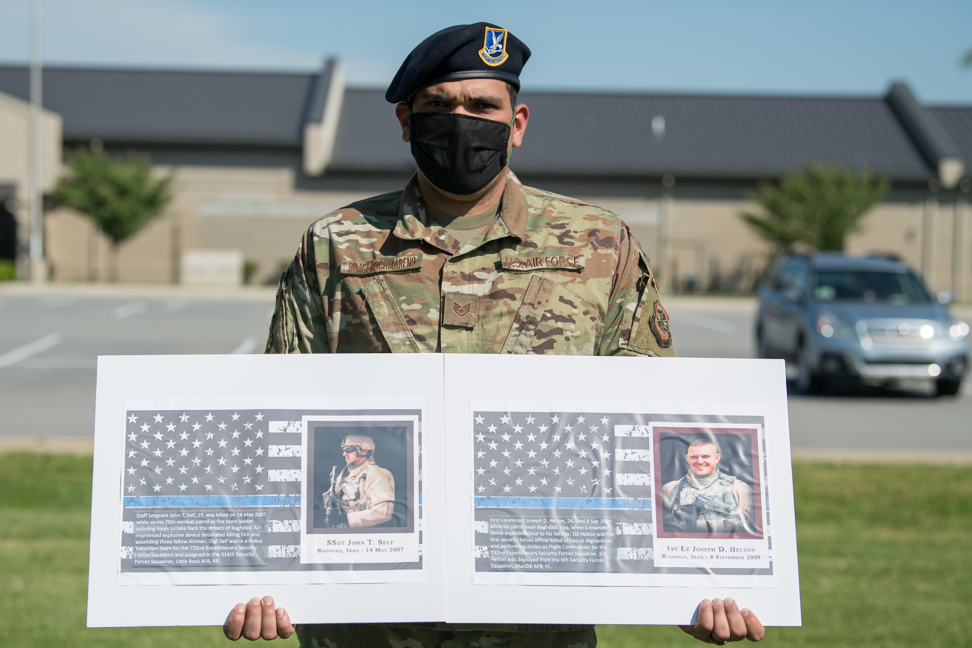 Staff Sgt. Jose Bracero-Camareno, 436th Security Forces Squadron combat arms instructor, holds photos of two fallen defenders during a retreat ceremony on Peace Officers Memorial Day May 15, 2020, at Dover Air Force Base, Delaware. The ceremony commemorating fallen military and civilian law enforcement officers marked the end of National Police Week 2020. (U.S. Air Force photo by Mauricio Campino)