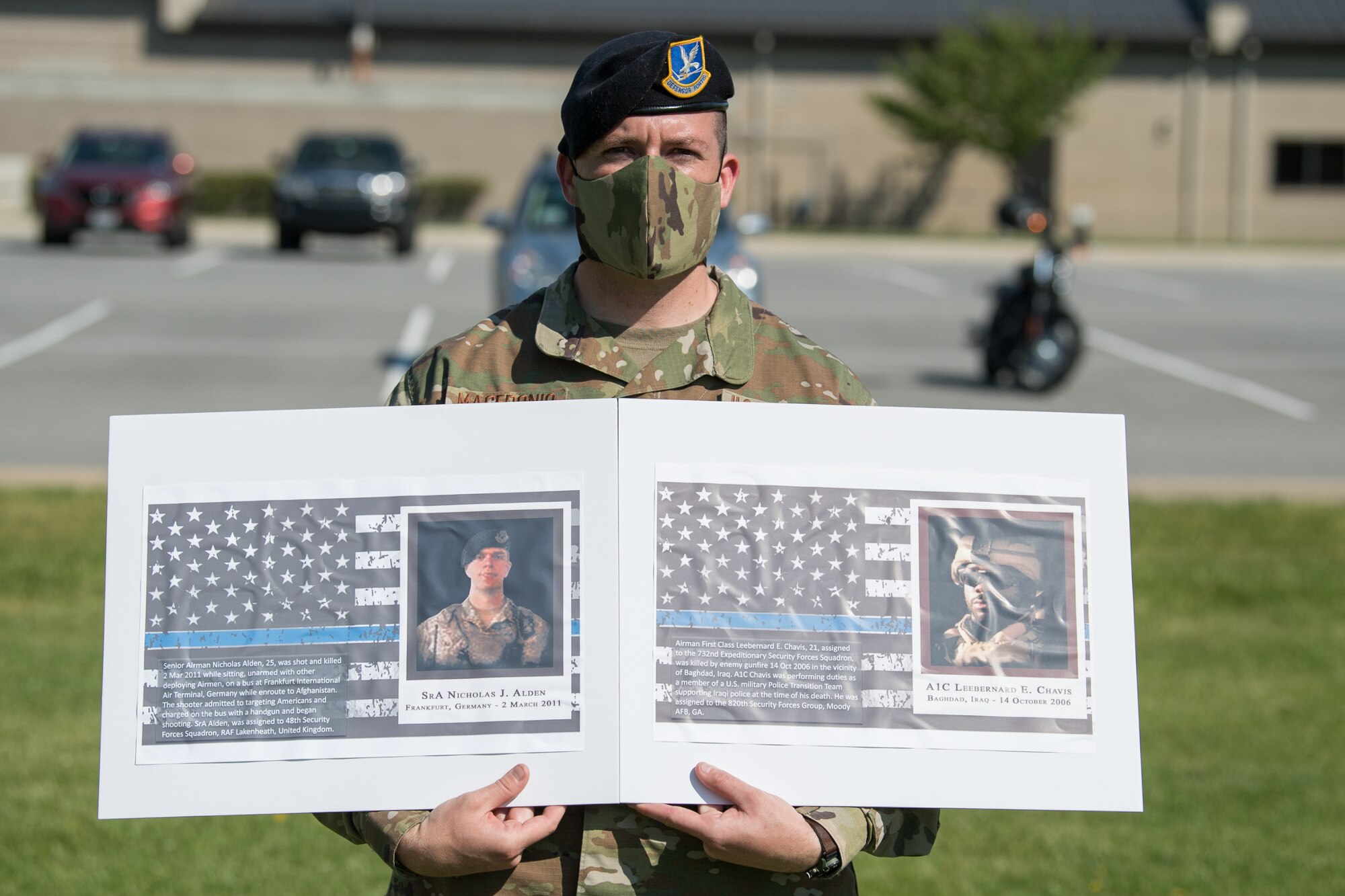 Master Sgt. Justin Macedonio, 436th Security Forces Squadron chief of standardization and evaluation, holds photos of two fallen defenders during a retreat ceremony on Peace Officers Memorial Day May 15, 2020, at Dover Air Force Base, Delaware. The ceremony commemorating fallen military and civilian law enforcement officers marked the end of National Police Week 2020. (U.S. Air Force photo by Mauricio Campino)