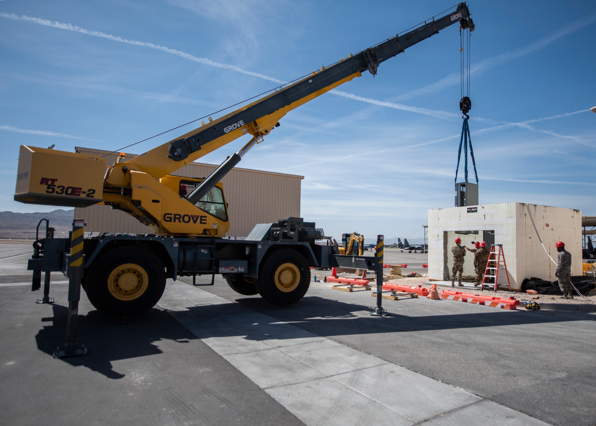 A 30-ton crane lifts a gearbox while Airman guide it into position.