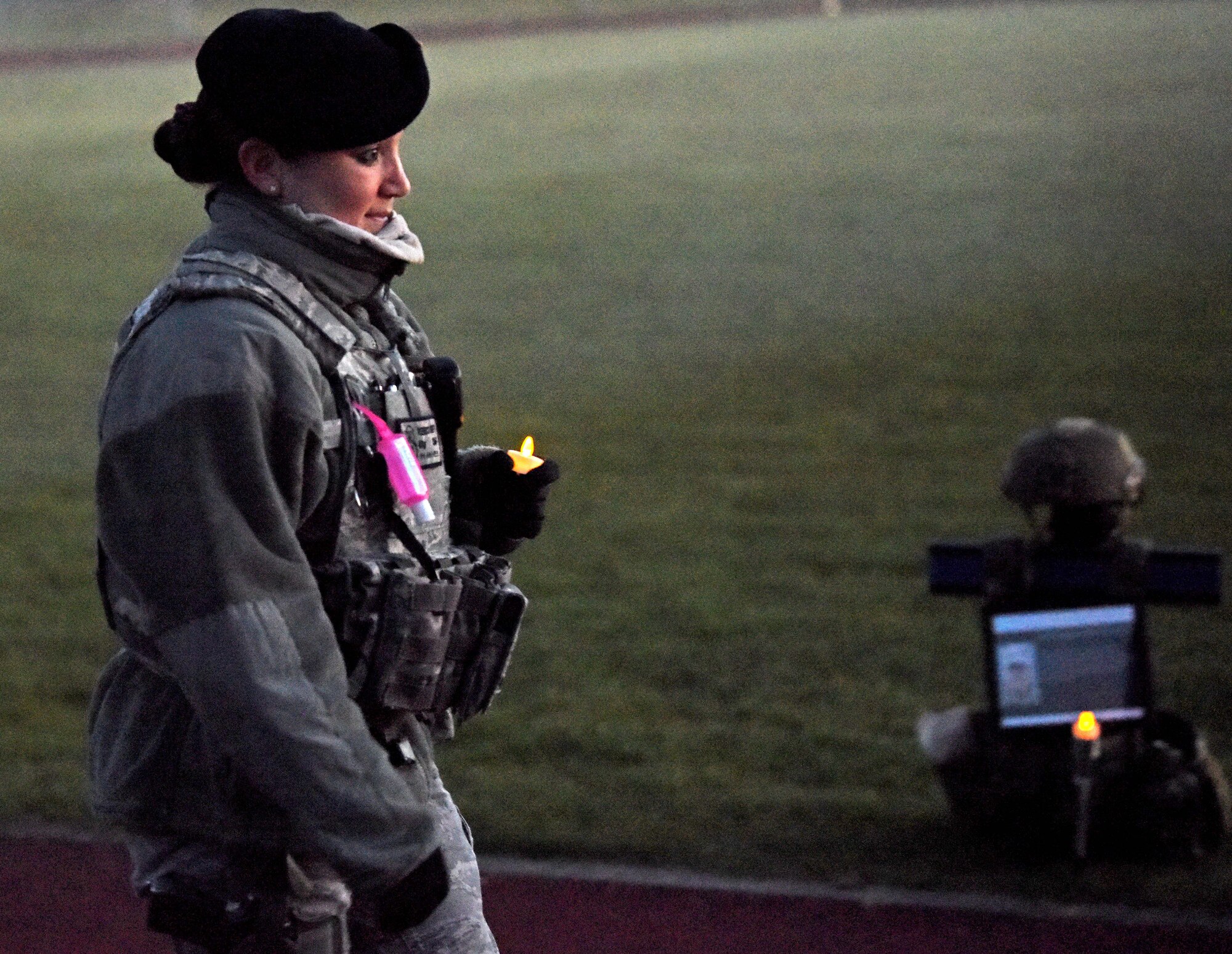 Master Sgt. Rebecca Swift, 100th Security Forces Squadron flight chief, walks during a candlelight vigil to honor the “Fallen 14” during events to commemorate National Police Week at RAF Mildenhall, England, May 14, 2020. The Fallen 14 represents the number of SF Airmen who’ve lost their lives in the line of duty since 9/11. (U.S. Air Force photo by Senior Airman Brandon Esau)