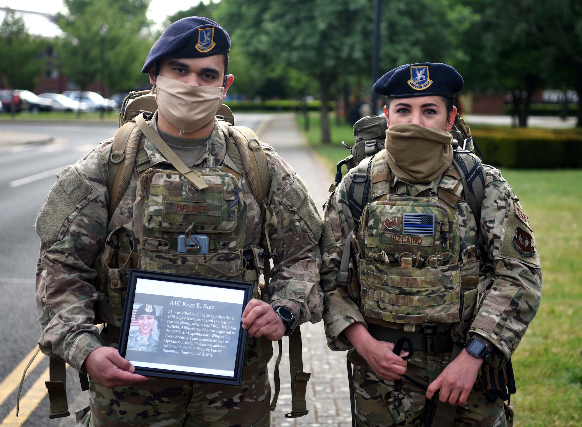 Staff Sgt. Anthony Bruner, 100th Security Forces Squadron member, and Tech. Sgt. Jessica Vizcaino, 100th SFS flight chief, pose with a photo of Airman 1st Class Kcey Ruiz during the 100th SFS Memorial Ruck March at RAF Mildenhall, England, May 13, 2020. Ruiz, a former security forces Airman, died in 2015 while deployed to Afghanistan in support of Operation Freedom’s Sentinel. (U.S. Air Force photo by Senior Airman Brandon Esau)
