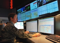 Senior Master Sgt. Donna Crone, pictured here at the 618th Air and Space Operations Center (Tanker Airlift Control Center) at Scott Air Force Base, Ill., works at her desk in TACC, Dec. 16, 2010. She is one of many planners and operators responsible for centralized command and control of Air Force and commercial contract air mobility assets 24 hours a day. The 618th AOC plans, schedules and tracks tanker, airlift and aeromedical evacuation aircraft worldwide to accomplish AMC's global reach mission.