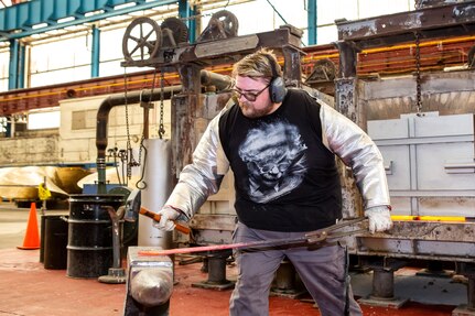 Norfolk Naval Shipyard (NNSY) Forging Shop (Shop 11F) Heavy Forger Chris Kanash works a piece of metal at the forge.