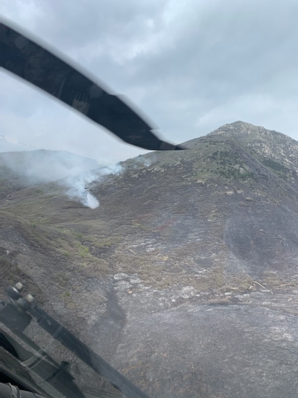 A Black Hawk helicopter from 2nd General Aviation Support Battalion, 211th Aviation Regiment, Utah National Guard drops water on the Saddle Fire in Midway, Utah, May 14, 2020.