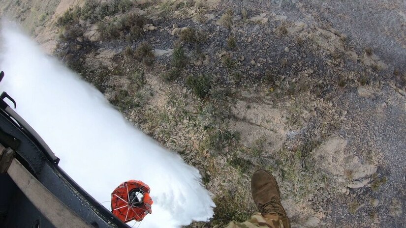 A Black Hawk helicopter from 2nd General Aviation Support Battalion, 211th Aviation Regiment, Utah National Guard drops water on the Saddle Fire in Midway, Utah, May 14, 2020.