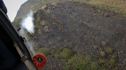 A Black Hawk helicopter from 2nd General Aviation Support Battalion, 211th Aviation Regiment, Utah National Guard drops water on the Saddle Fire in Midway, Utah, May 14, 2020.