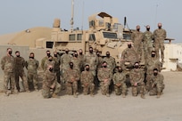 Service members from the U.S. and Australia stand together while wearing masks made for them, by Annette Frye on May 8, 2020 in Kuwait. Annette is mother of EOD technician Master Sgt. Ronnie Brickey, part of Task Force Hellhound in Kuwait.