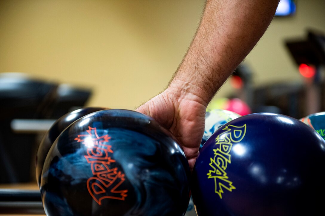 Photo of patron grabbing his bowling ball.