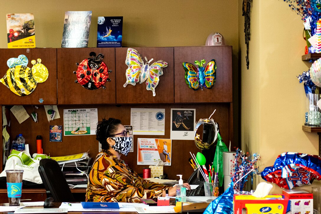 Photo of reservation aid working on her computer.