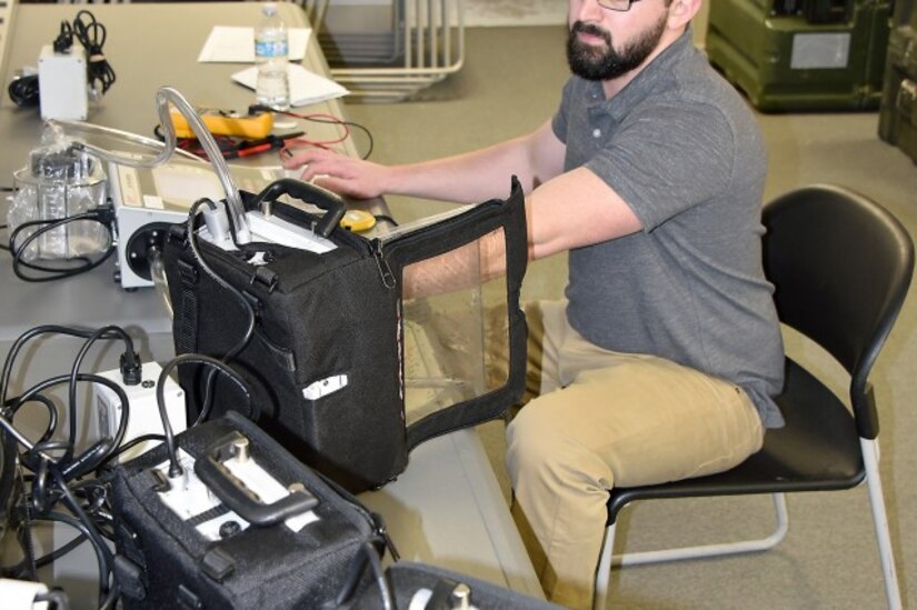 Dean Edwards, a contractor working as a Biomedical Equipment Technician (BMET) from MMOD-Tobyhanna, tests aspirator machines during a maintenance trip to assist a Maryland National Guard unit in February. MMOD-Tobyhanna is one of three regional Medical Maintenance Operations Divisions operated by the U.S. Army Medical Materiel Agency, a direct reporting unit to Army Medical Logistics Command.