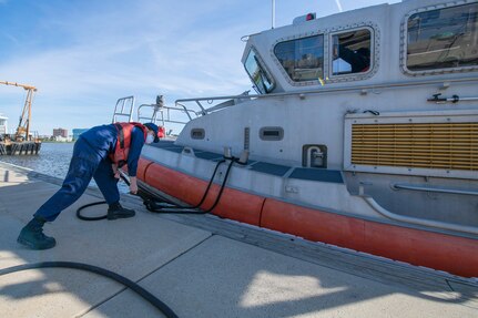 Fireman Catherine Kimball, line handler, waits for commands to release the line prior to Man Overboard training May 12, 2020, at Coast Guard Station Charleston, S.C.