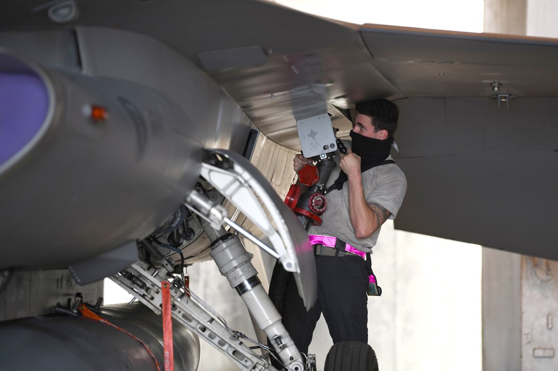 An airman refuels a military aircraft.