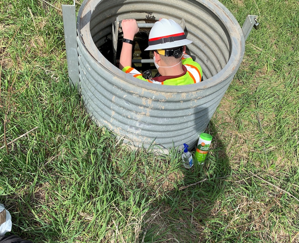 Narturi Narciso, engineer in training, U.S. Army Corps of Engineers, Omaha District,enters a conduit at a conduit to inspect the drainage system at Salt Creek Site 2, Olive Creek Dam, Neb., to check for erosion and if the outlet channel in satisfactory condition May 1. This was the first inspection the dam safety program conducted since the COVID-19 pandemic began.