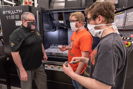 Photo supervisor and employees testing the effectiveness of a new see-through mask