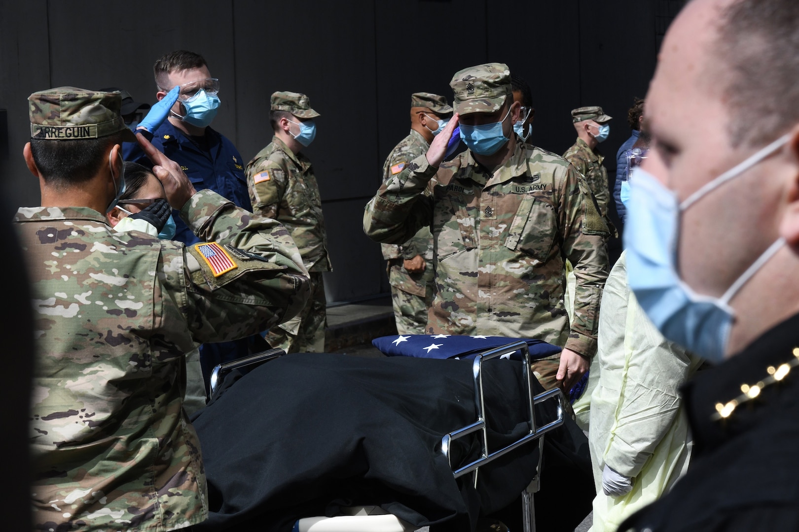 masked soldiers salute at funeral