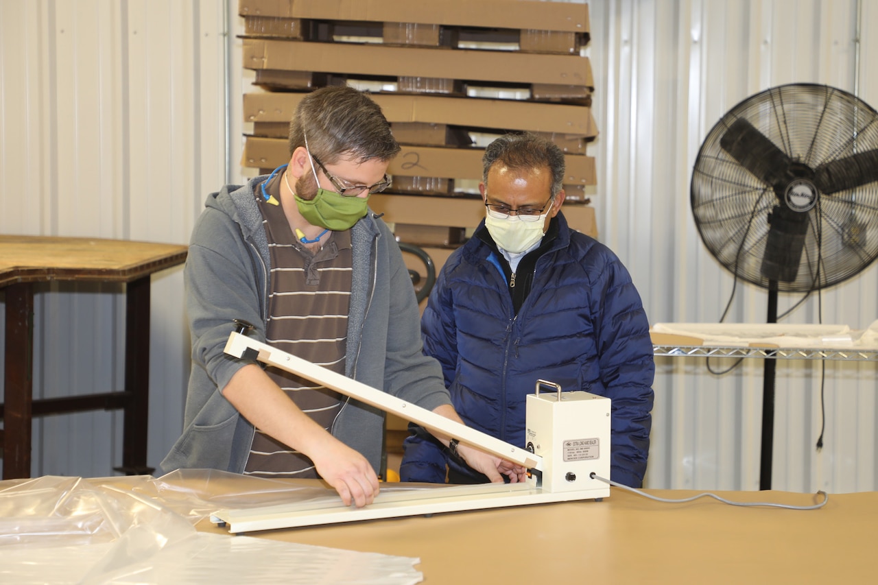 Letterkenny Army Depot personnel discussing production of isolation gowns with WellSpan.