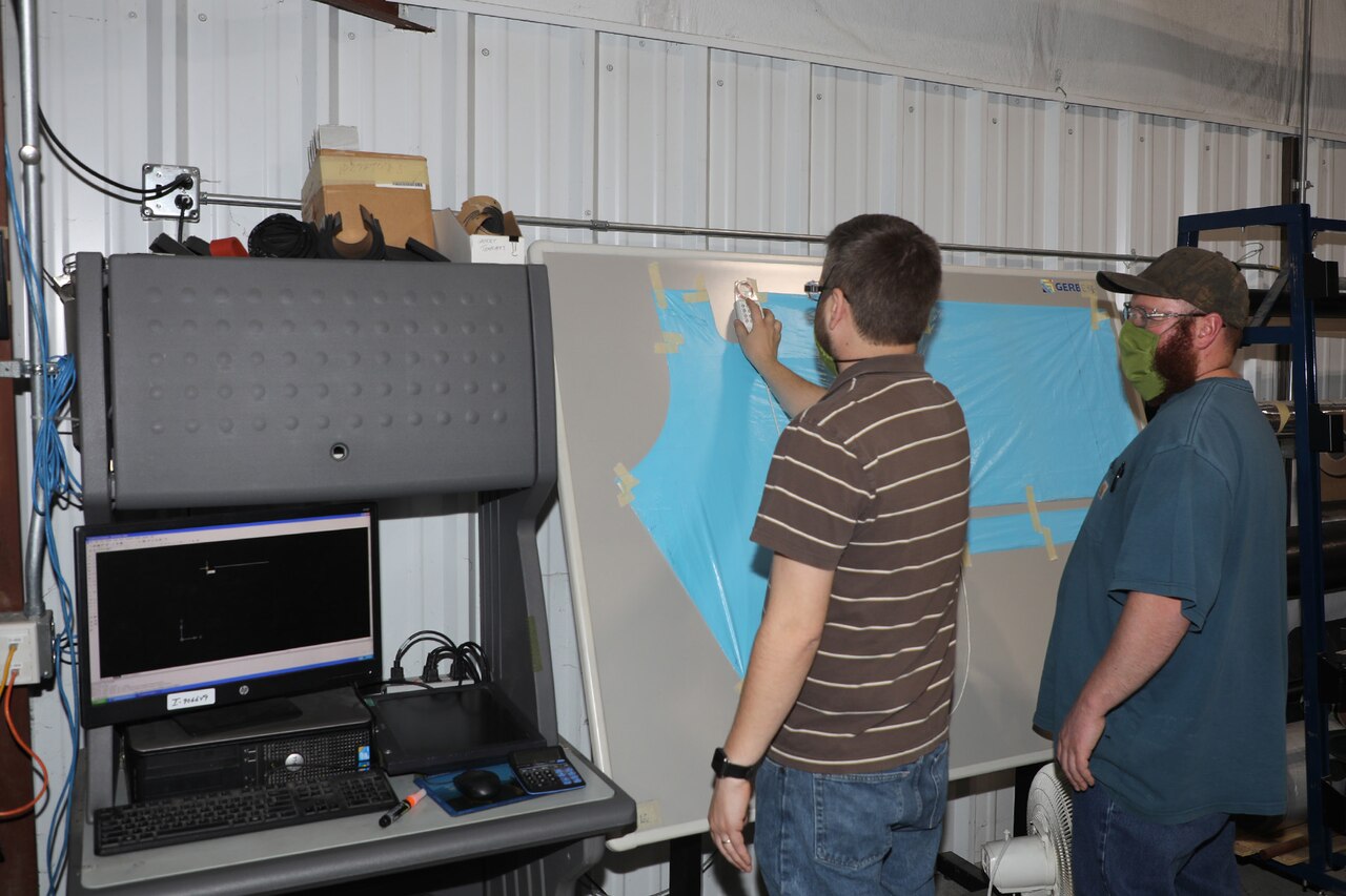 Letterkenny Army Depot personnel discussing production of isolation gowns with WellSpan.