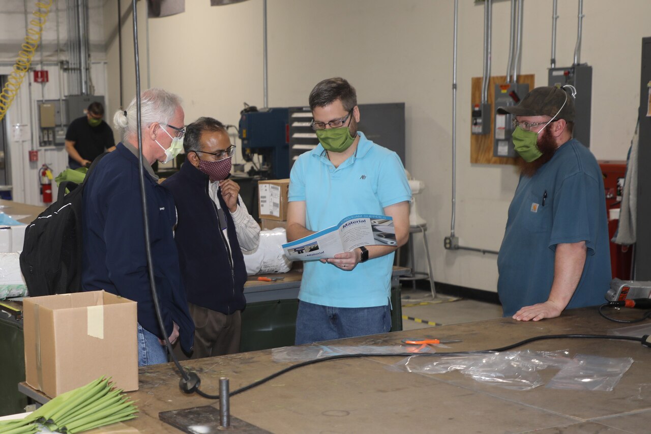Letterkenny Army Depot personnel discussing production of isolation gowns with WellSpan.