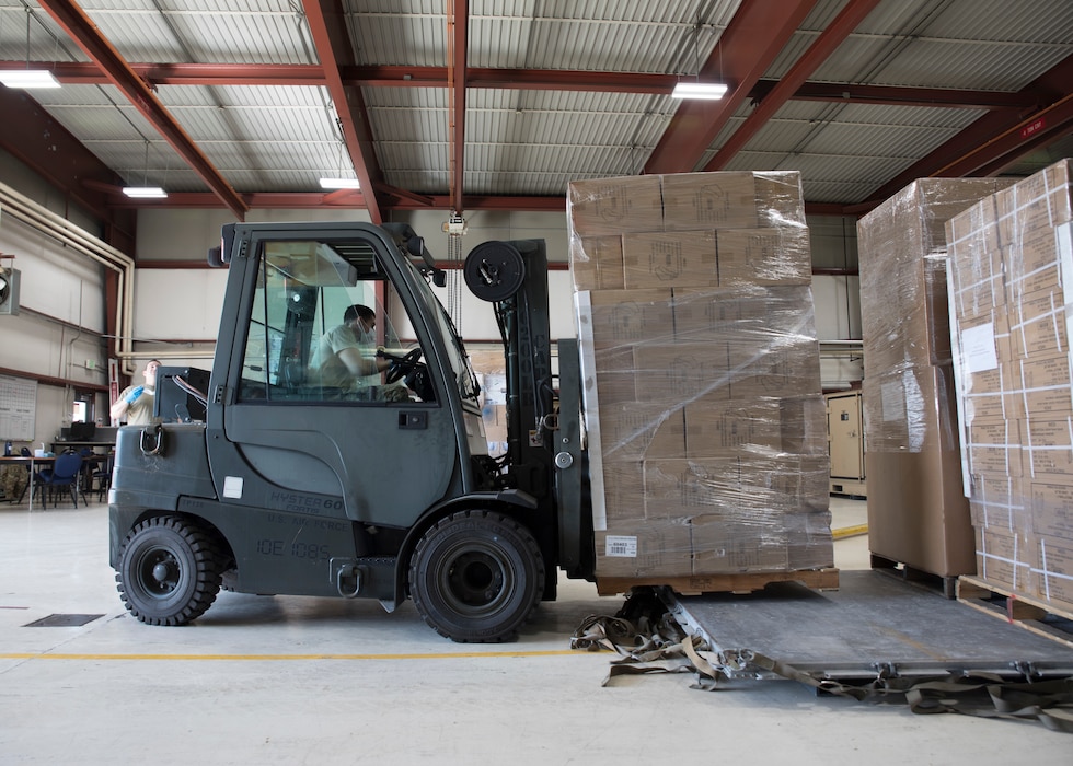 Senior Airman Peter Zuniga, 151st Logistics Readiness Squadron Aerial Port, operates a forklift while loading aircraft pallets of donated goods in preparation for airlift to the nation of Ecuador, April 9, 2020 at Roland R. Wright Air National Guard Base, Utah