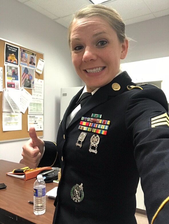 Female Soldier takes a selfie in her Army Service Uniform in her office.