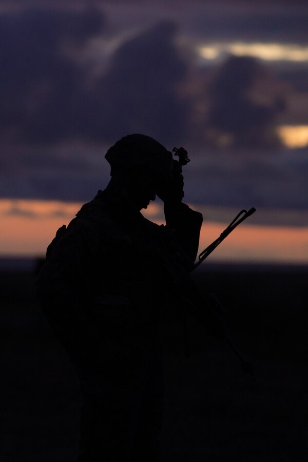 A U.S. Marine with Alpha Company, Battalion Landing Team 1/4,15th Marine Expeditionary Unit, listens to a radio call during a helicopter raid course Marine Corps Base Camp Pendleton, California, May 12-13, 2020. The training was conducted to enhance participants’ tactics, techniques and procedures applicable to air raid operations for an upcoming deployment. (U.S. Marine Corps photo by Cpl. Sarah Stegall)