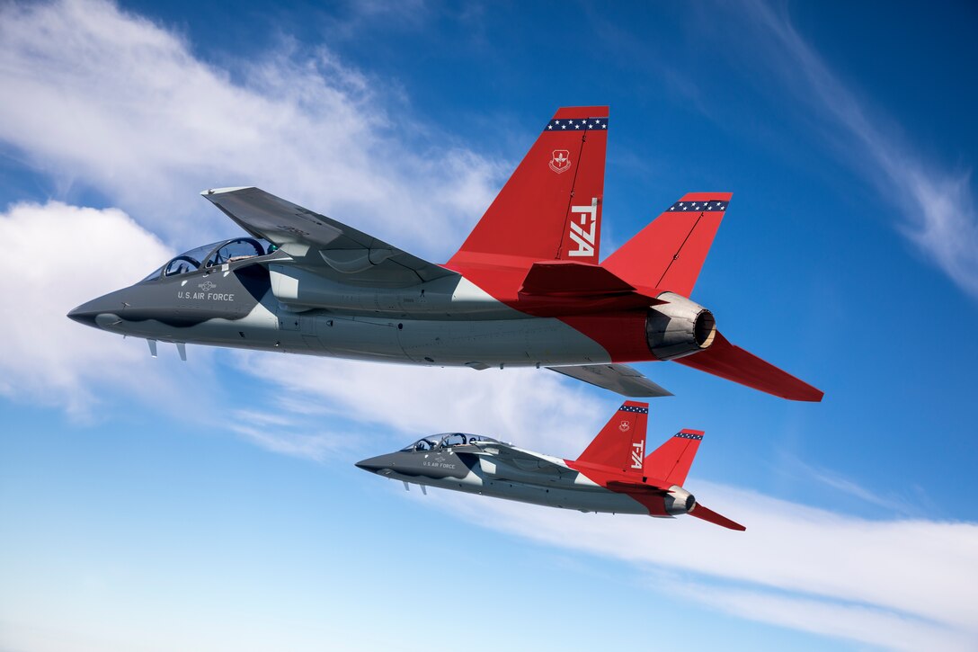 Two T-7A test jets soar over St. Louis during a test flight, April 24, 2017. On April 30, 2020, the T-7A Test Team executed the first real-time Distributed Test Operations with the T-7A in a mission control room at Ridley Mission Control Center at Edwards AFB. The T-7A Red Hawk is part of the new advanced pilot training system for the U.S. Air Force that will train the next generation of pilots and is scheduled to replace the current T-38.  (Credit: E.Shindelbower/BOEING COMPANY ● ALL RIGHTS RESERVED)