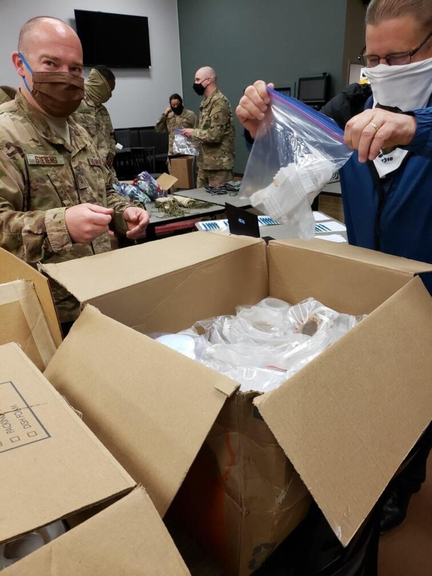 Members of the 11th Security Support Squadron unbox personal protective equipment received through a pilot initiative called the Air Force Rapid Agile Manufacturing Platform at Joint Base Andrews, Md., May 15, 2020. The framework is designed to keep the Air Force supply system independent of the civilian medical market. (U.S. Air Force courtesy photo)
