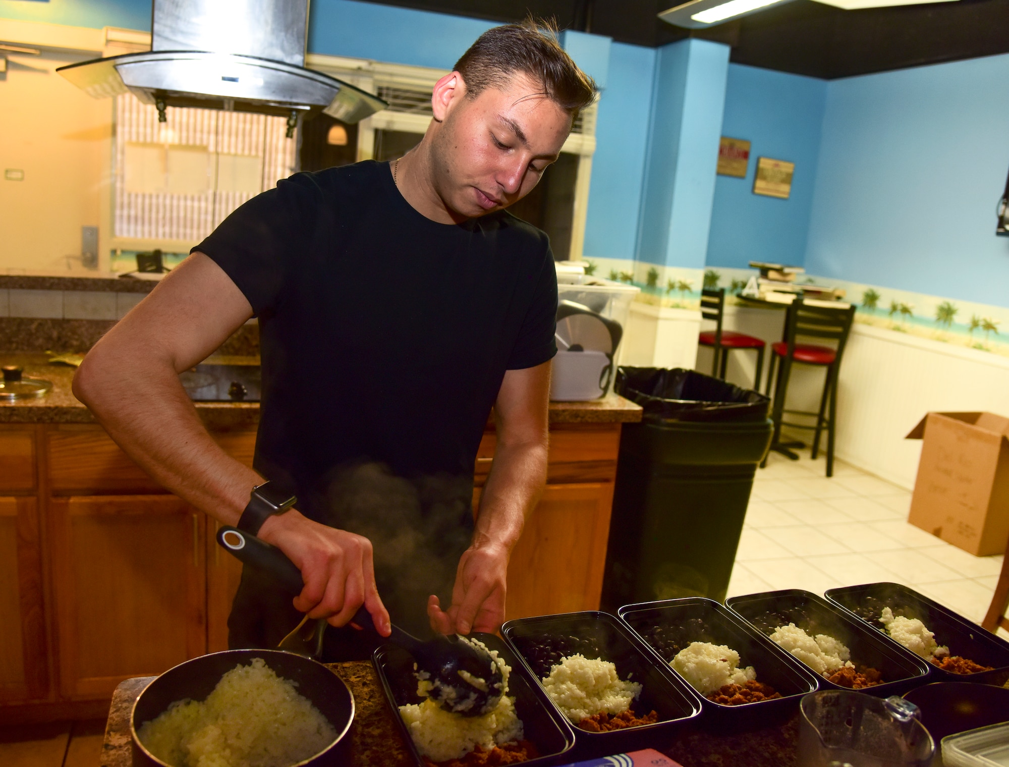 Airman 1st Class Matthew Blasberg, 47th Healthcare Operations Squadron referral management and patient travel technician, separates the portions, May 5, 2020 at Laughlin Air Force Base, Texas. Blasberg did not eat the healthiest diet as he was growing up, which led to him feeling less confident and not as comfortable in his own skin. He continues to learn about healthy diets, and he experiments on what his ideal diet consists of. With strong determination, he creates nutritious meals for breakfast, lunch and dinner.  (U.S. Air Force photo by Senior Airman Anne McCready)