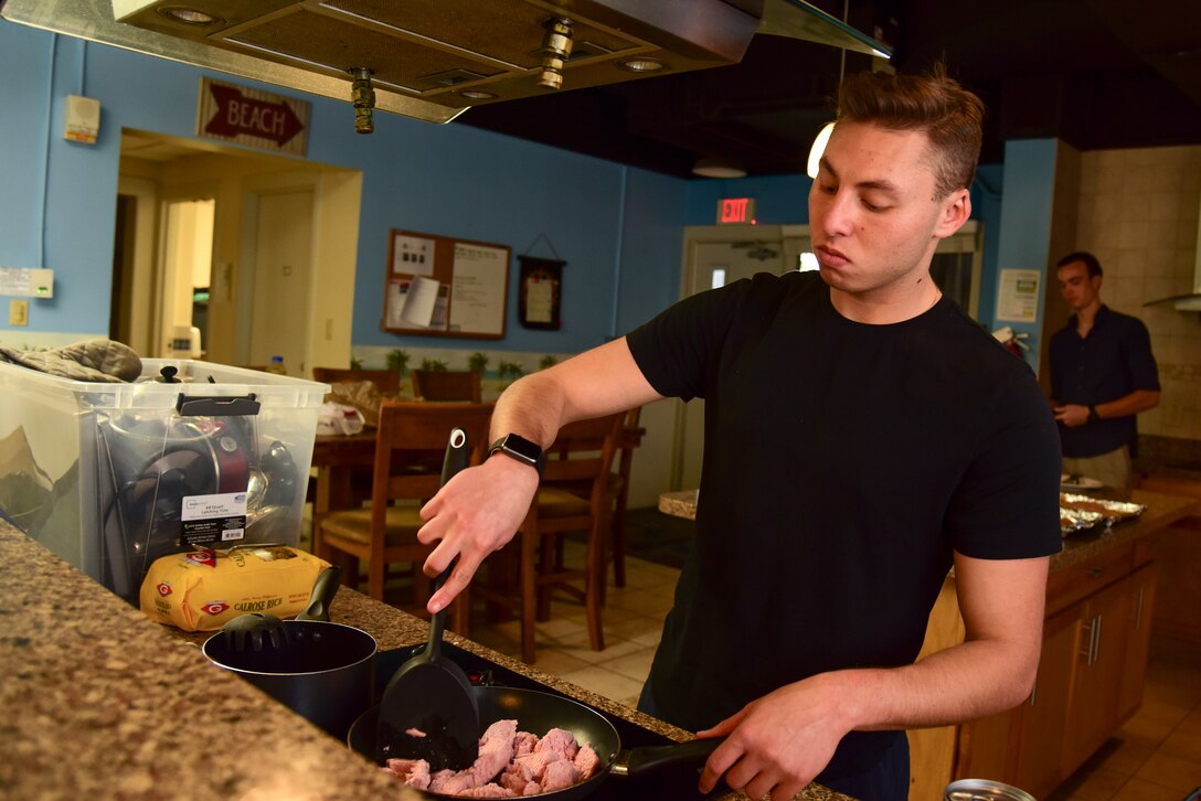 Airman 1st Class Matthew Blasberg, 47th Healthcare Operations Squadron referral management and patient travel technician, stirs ground turkey as it cooks on the stove, May 5, 2020 at Laughlin Air Force Base, Texas. Blasberg didn’t always know how to put together his own meals. However, with the help of the internet, he’s discovered how to make his own nourishing creations. (U.S. Air Force photo by Senior Airman Anne McCready)