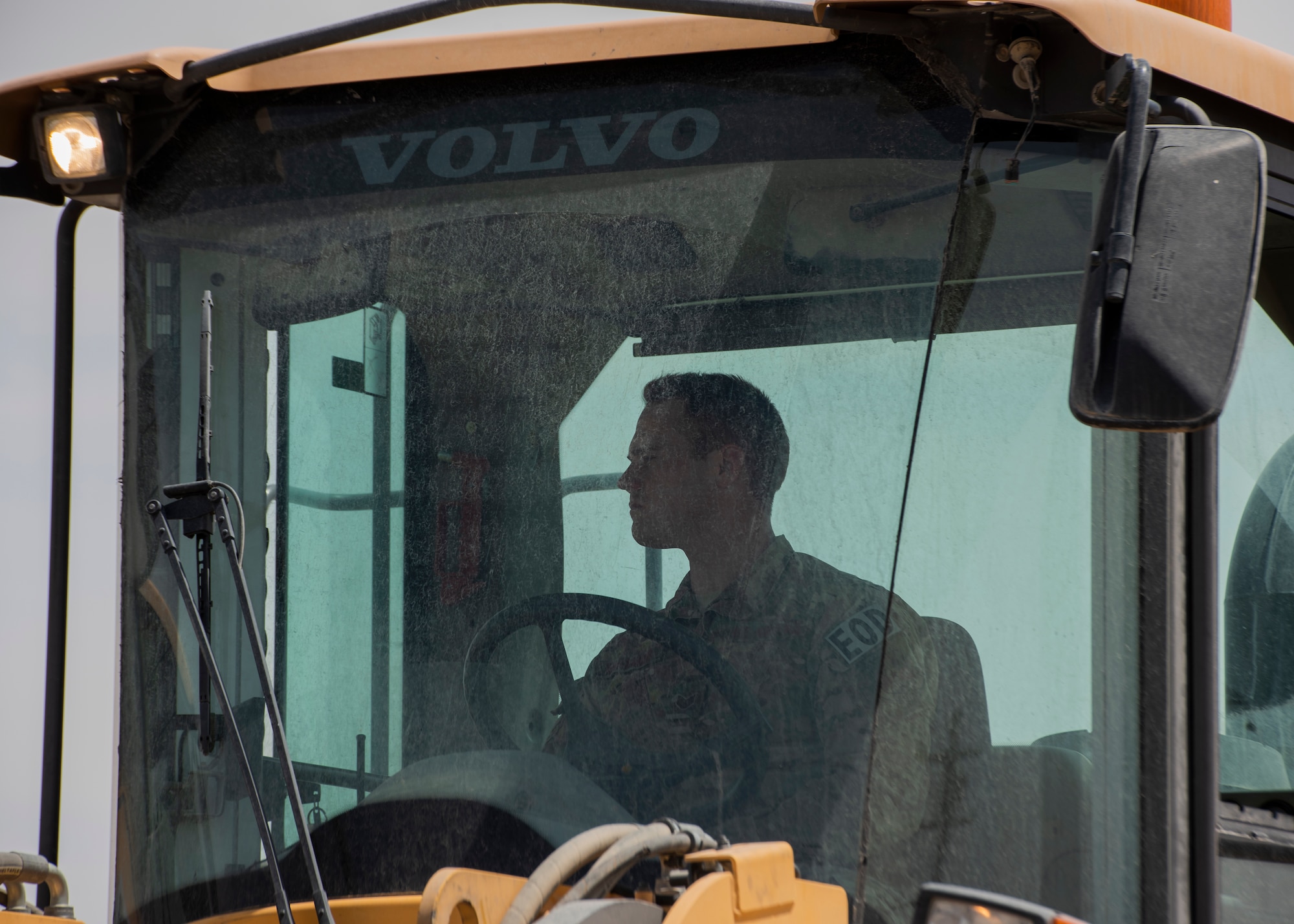 Airmen use heavy equipment to clear debris from runway.