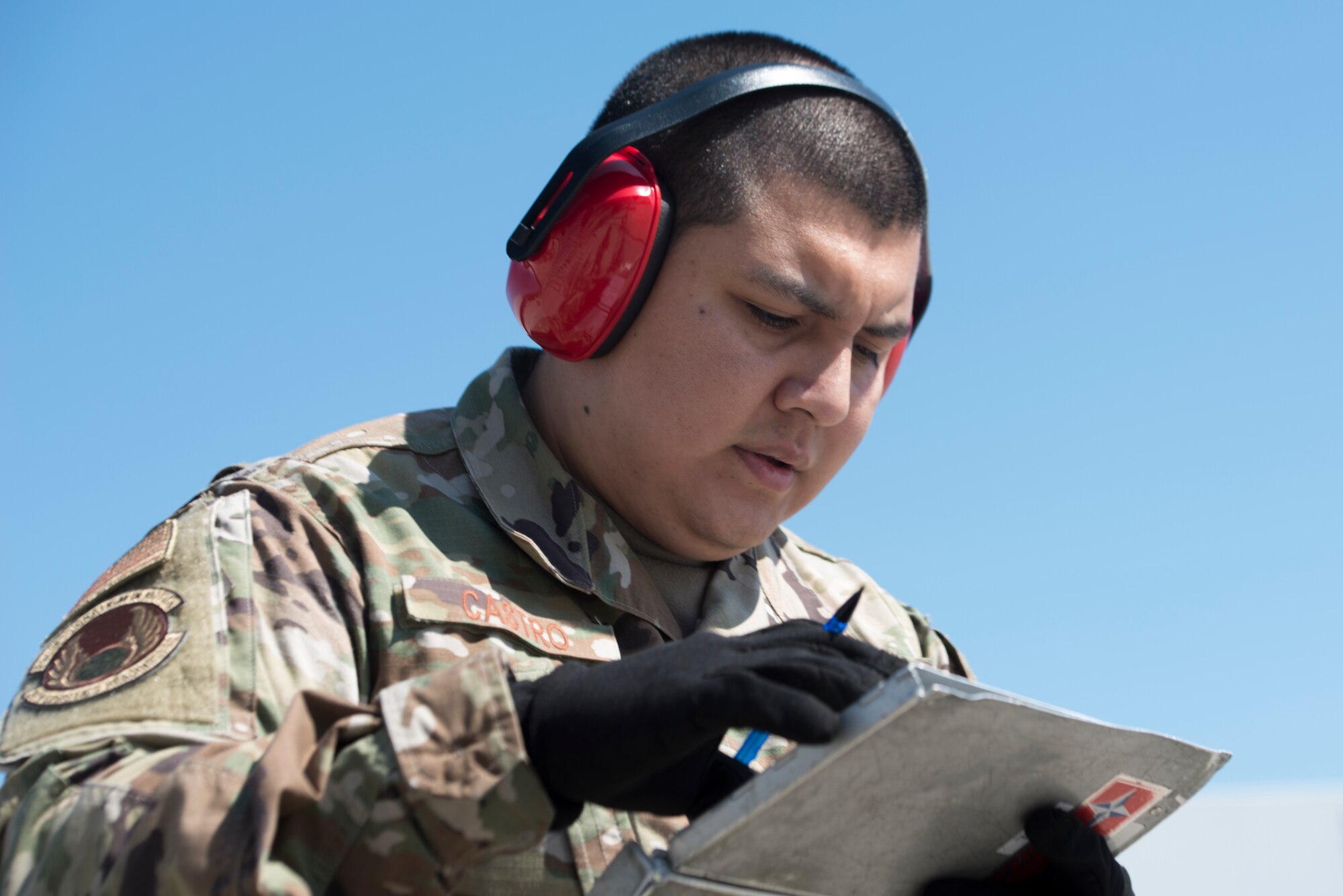 A photo of an Airman checking notes.