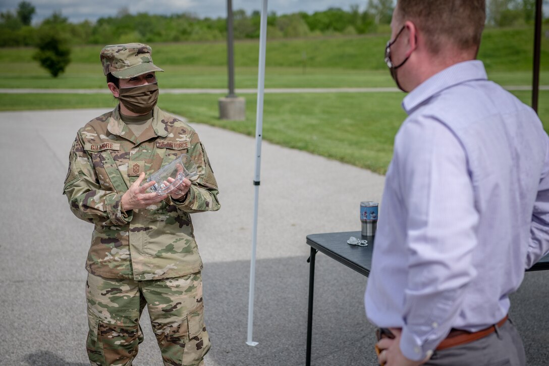 932nd Airlift Wing Command Chief Barbara Gilmore, presents Chief Master Sgt. Darren Wiseman, former 932nd Airlift Wing Inspector General for Inspections superintendent, the coveted 932nd Wing mug during Wiseman's farewell ceremony May 15, 2020, Scott Air Force Base, Illinois. Wiseman is taking on a new military role as the Headquarters Air Force Reserve Command Force Generation Center superintendent and moving over to Air Mobility Command as the Lead Unit Deployment Manager in his civilian career. (U.S. Air Force photo by Christopher Parr)