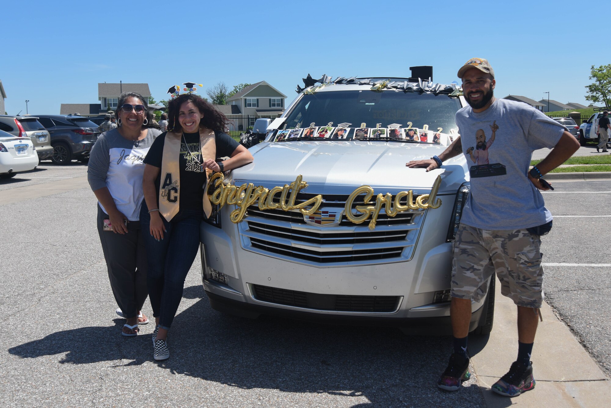 The Williams family pose for a photo before riding through the parade to celebrate the graduation of Jazzy Williams, Andover Central High School graduate, May 18, 2020, at McConnell Air Force Base, Kansas. Team McConnell hosted a drive-through parade on base to honor high school and college seniors graduating in the midst of COVID-19. (U.S. Air Force photo by Airman 1st Class Marc A. Garcia)